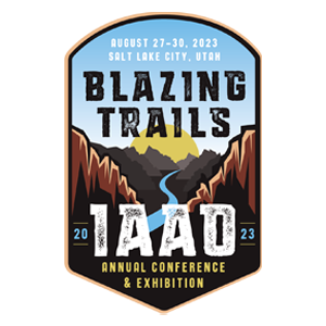 Logo is an illustration of two canyons with a river between them, leading to a sunrise behind mountains. Text reads: "August 27-30, 2023. Salt Lake City, Utah. Blazing Trails. 2023 IAAO Annual Conference & Exhibition."